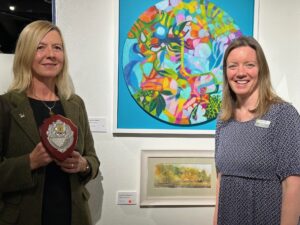 Helen Whamond and her work 'Autumn Reflections', a purchase prize winner of the 2025 Meffan Winter Show. Helen is pictured with Kirsty Hunter Chief Executive of ANGUSalive.